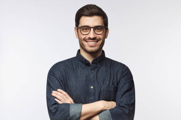 istock Confident guy standing with arms crossed, smiling, ready to help, isolated 1161827719