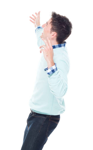 istock Handsome young man looking up in surprise 1161827764