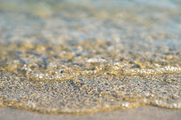 istock close up of a wave rolling onto the beach 1161839419