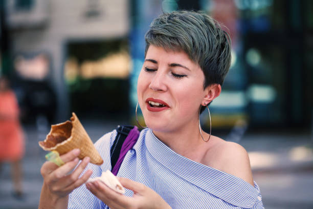 istock Beautiful woman eating ice-cream 1161841827
