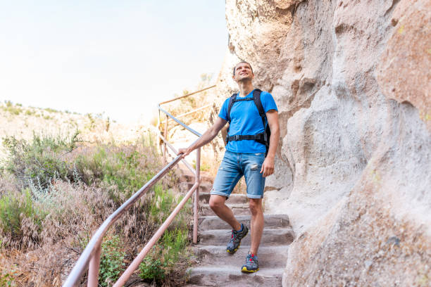 istock Los Alamos park with man hiking walking on steps of Main Loop trail path in Bandelier National Monument in New Mexico 1161845522
