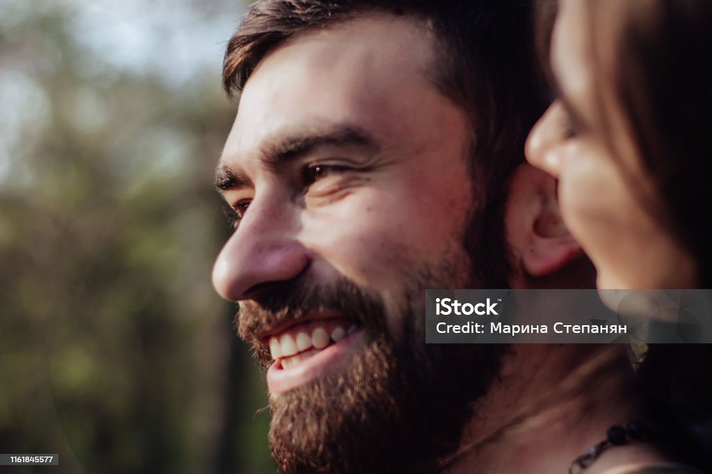 Head shot of young affectionate romantic couple in love. Close up portrait of attractive brunette girl and guy with eyes closed, close to each other. Concept of first kiss, tenderness and amorousness Adult Stock Photo