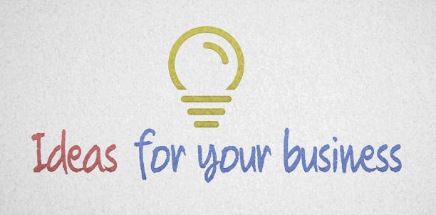 message "idées pour votre entreprise" avec icône d'ampoule dessinée sur papier - light bulb inspiration ideas inks on paper photos et images de collection