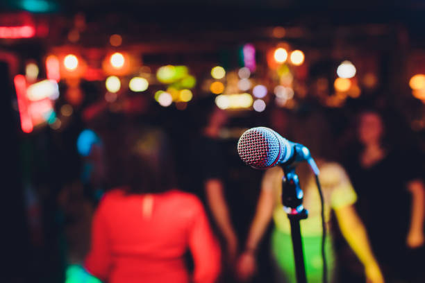 istock Microphone on stage against a background of auditorium. 1161854978