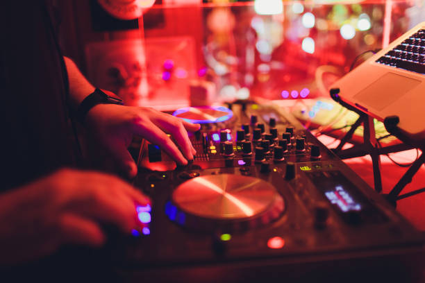istock DJ turntable console mixer controlling with two hand in concert nightclub stage. 1161854980