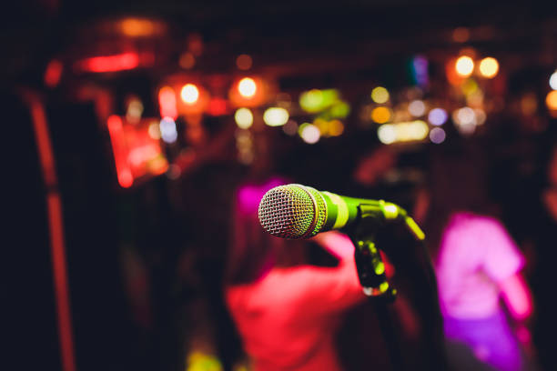 istock Microphone on stage against a background of auditorium. 1161854981
