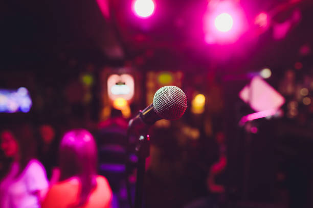 istock Microphone on stage against a background of auditorium. 1161854984