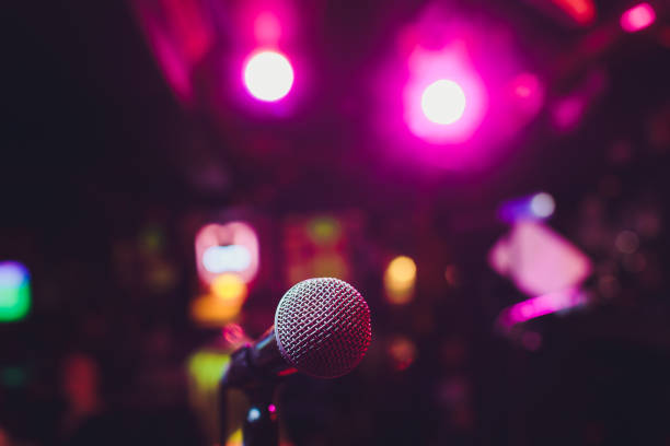 istock Microphone on stage against a background of auditorium. 1161854986