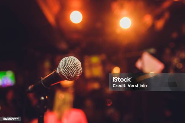Microphone On Stage Against A Background Of Auditorium Stock Photo - Download Image Now
