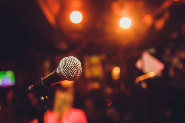 microphone on stage against a background of auditorium. - performance imagens e fotografias de stock