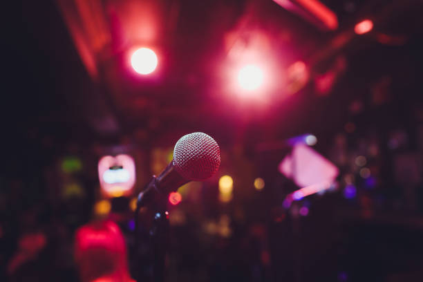istock Microphone on stage against a background of auditorium. 1161854996