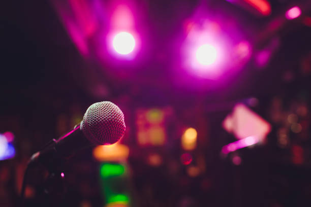 istock Microphone on stage against a background of auditorium. 1161855010