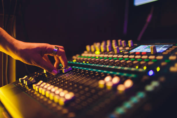 istock DJ turntable console mixer controlling with two hand in concert nightclub stage. 1161855044