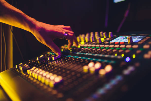 istock DJ turntable console mixer controlling with two hand in concert nightclub stage. 1161855049