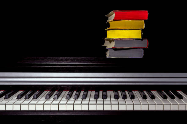 istock stack of colored books on the piano on a black background 1161857893