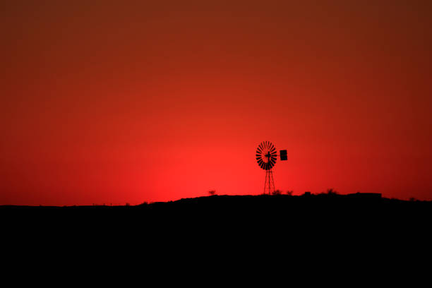 Outback windmill at sunrise stock photo