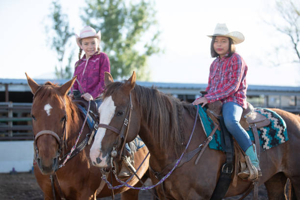 istock Little cowgirls with their horses 1161865577