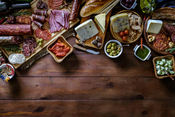 istock Tapas of cured ham and cheese delicious appetizer on rustic wood table with copy space 1161866284