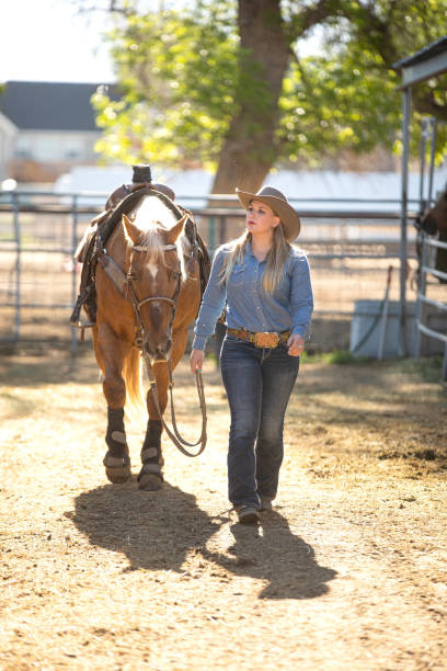 istock Cowgirl with her horse 1161868447