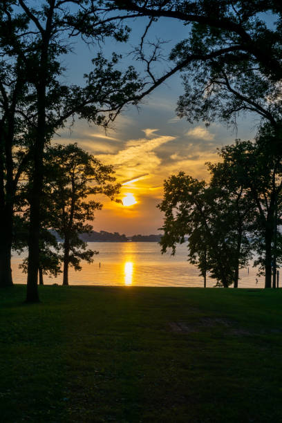 istock Beautiful Sunset By The Lake With A Boat Silhouette 1161873065