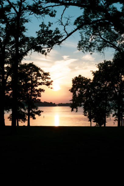 istock Beautiful Sunset By The Lake With A Boat Silhouette 1161873067