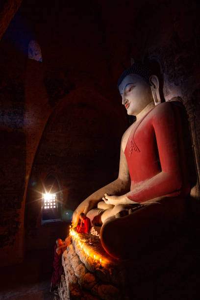 istock Monk in Bagan old town pray a buddha statue with candle, bagan city 1161879401