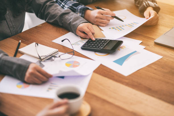 istock a businessman using calculator in a business meeting 1161881689