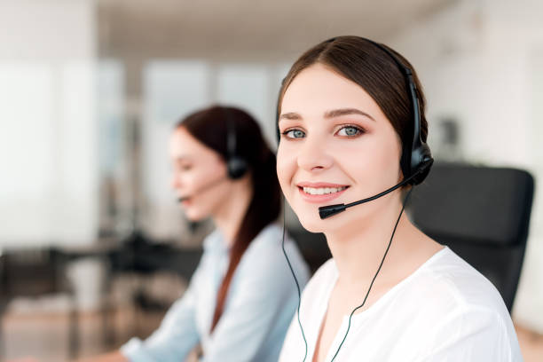 istock Call center operator answering clients in a company with tech support 1161883615