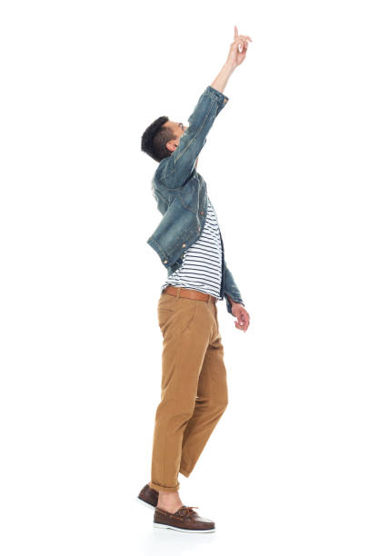 istock Good looking tall black man wearing denim jacket - pointing up 1161890122