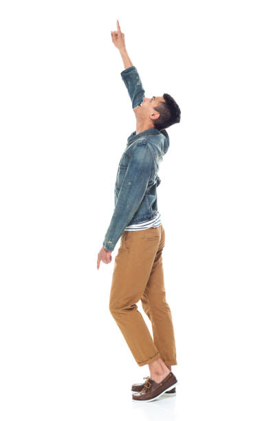 istock Good looking tall black man wearing denim jacket - pointing up 1161890128