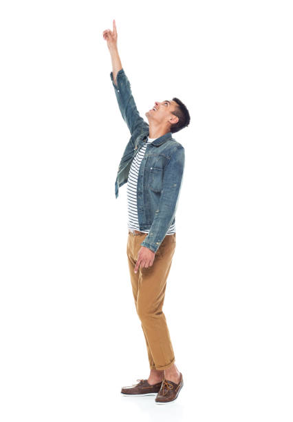 istock Good looking tall black man wearing denim jacket - pointing up 1161890136