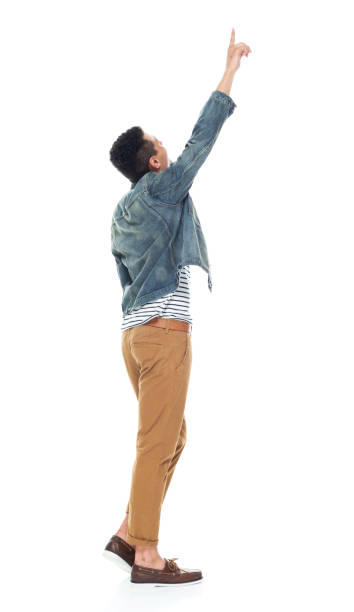 istock Good looking tall black man wearing denim jacket - pointing up 1161890138