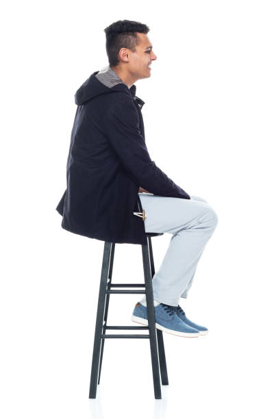 istock Handsome African American male standing on white background - sitting 1161890249