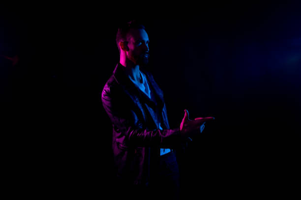 istock Attractive man with white shirt and leather jacket and gel lighting 1161890918