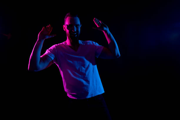 istock Handsome man in white tshirt with gel lighting 1161890984