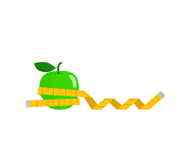 zielone jabłko owinięte taśmą izolowane na białym tle. - tape measure apple dieting measuring stock illustrations