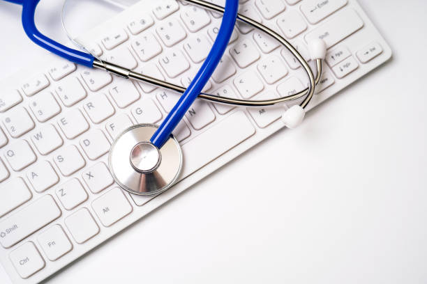istock Medical Concept - Stethoscope on computer keyboard on white background. Physician long term care treatment concept. Top view, flat lay, copy space 1161891179