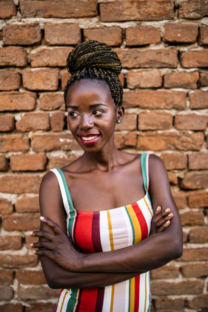 istock African woman talking on smart phone in front of brick wall 1161893202