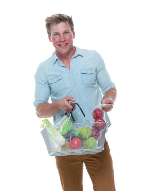 istock Handsome male holding shopping basket with vegetables 1161894814