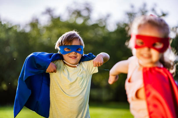 istock Cute boy and girl playing superhero 1161897642