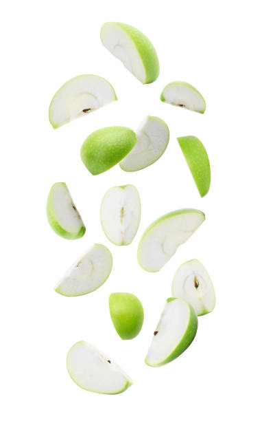 Slice ripe green apple falling isolated on white background with clipping path Slice ripe green apple falling isolated on white background with clipping path. green apple slice stock pictures, royalty-free photos & images