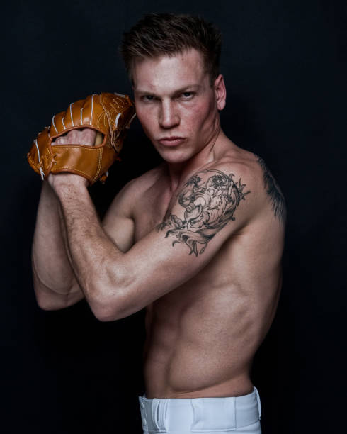 istock Sexy baseball player on black background 1161902734