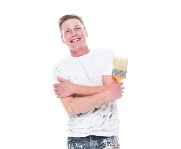 istock Young attractive male painter standing on white background - smiling 1161902931