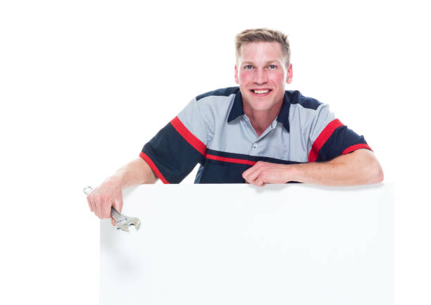 istock Handsome young male mechanic standing next to a big placard - resting on top 1161903721