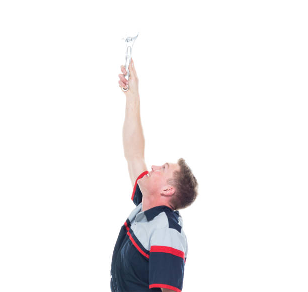 istock Young handsome male mechanic standing on white background - pointing up 1161903727