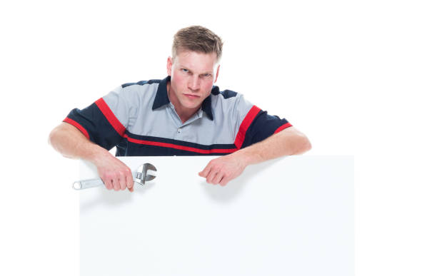 istock Handsome young male mechanic standing next to a big placard - angry 1161903733