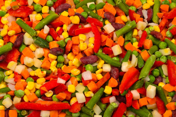 istock Sliced vegetables, corn, beans, peas, carrots, sweet peppers background. 1161905603