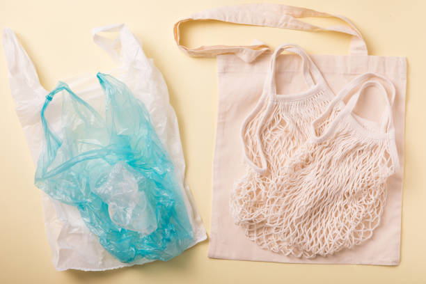 istock Canvas cotton shopping eco friendly bag and plastic bag over white background. Zero waste, plastic free concept. Top view, flat lay. Caring for the environment 1161909805