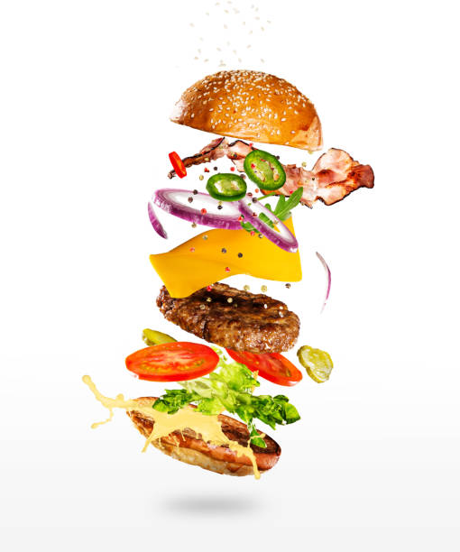 istock Tasty hamburger with flying ingredients on white background 1161910956