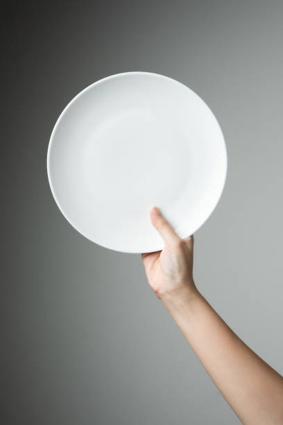 istock chef uniform with white empty plate welcome present dish restaurant promotion 1161911139